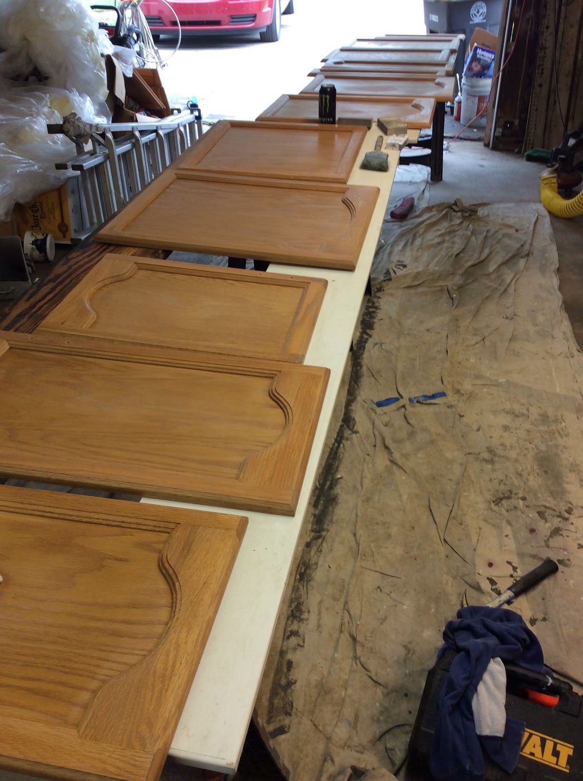 Cabinet doors laid out on drop cloths to dry on a Fort Wayne job site