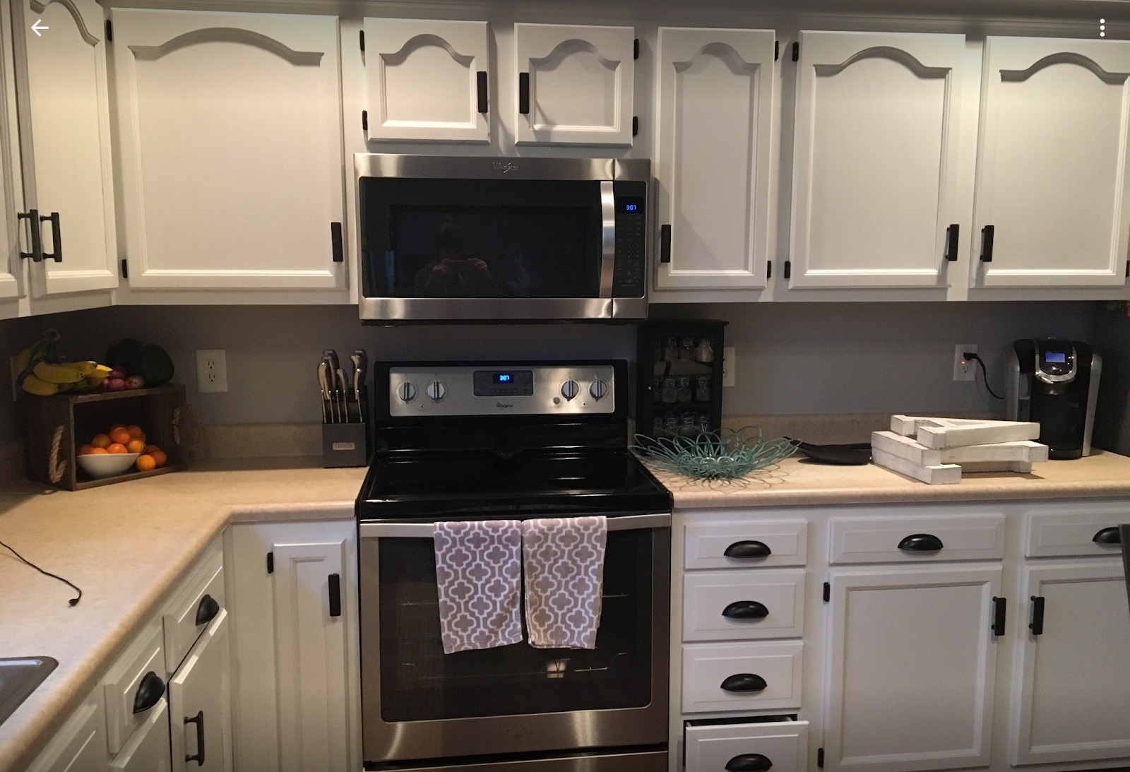 Kitchen cabinets refinished white with black hardware