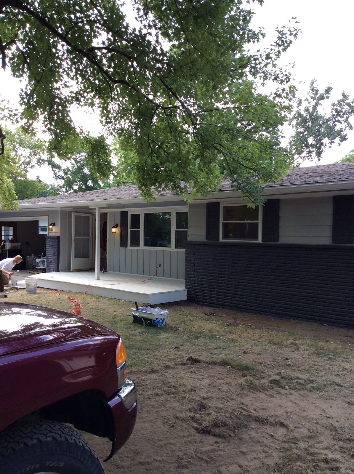 Ranch home repainted deep charcoal with white porch trim